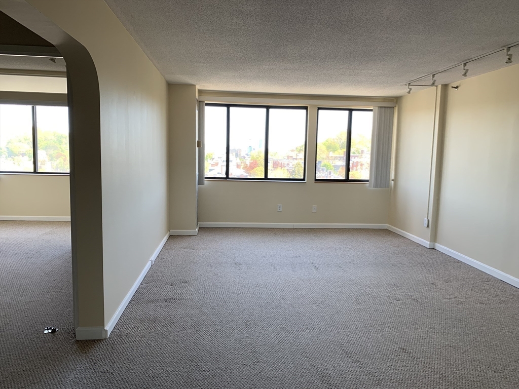 1731 Beacon Street, Unit 1213 Brookline, MA 02445 - Photo 22 of 29 an empty room with windows and closet