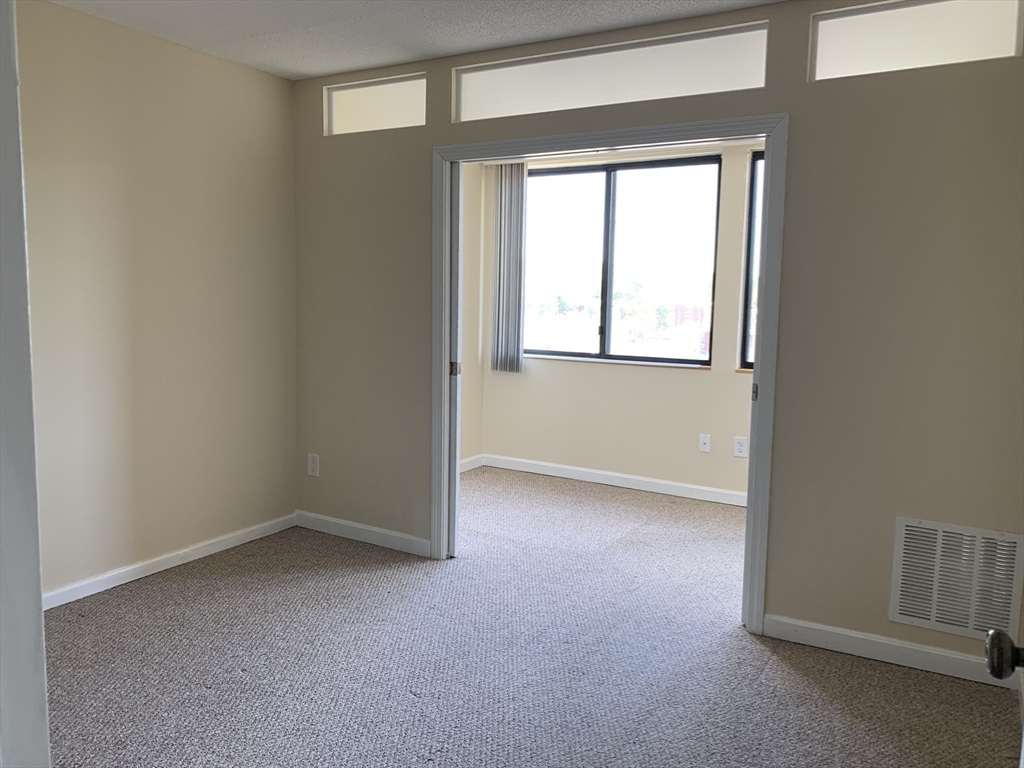 1731 Beacon Street, Unit 1213 Brookline, MA 02445 - Photo 24 of 29 an empty room with a window