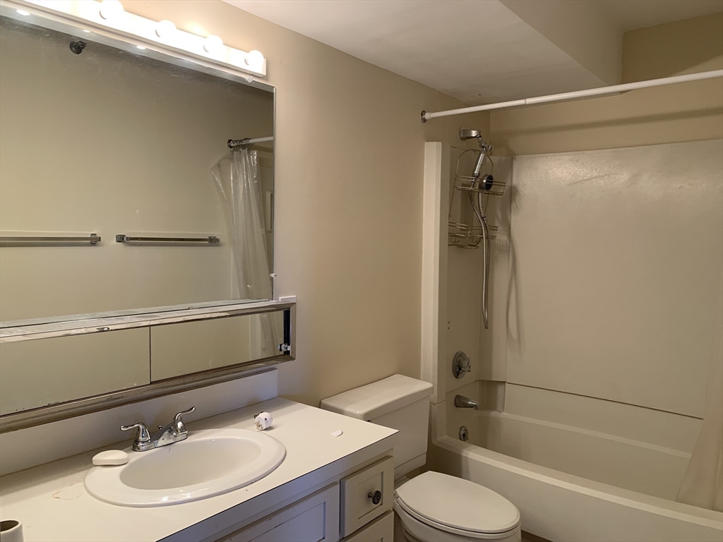 1731 Beacon Street, Unit 1213 Brookline, MA 02445 - Photo 28 of 29 a bathroom with a sink toilet and shower