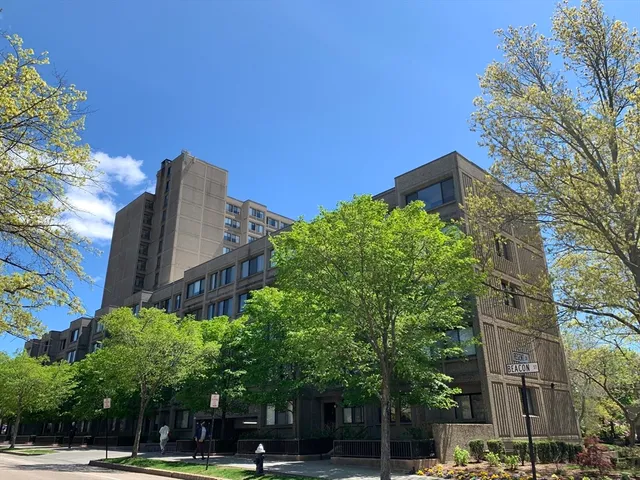 a view of a tall building next to a road