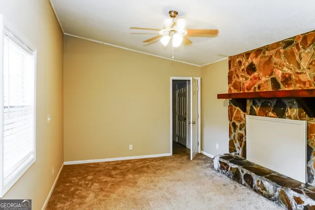 a view of room with window and a ceiling fan