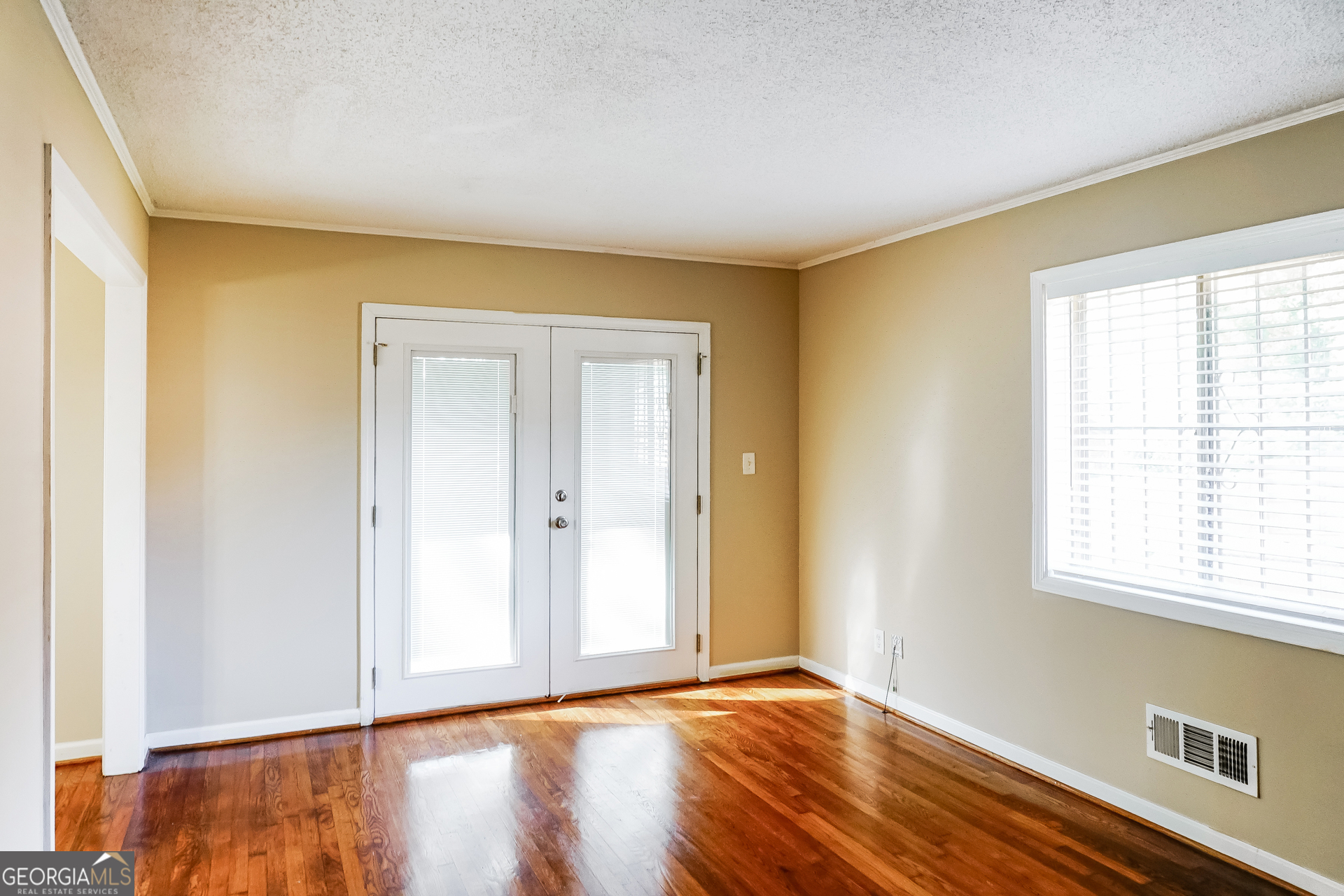 3762 Elkridge Drive Decatur, GA 30032 - Photo 7 of 16 a view of an empty room with wooden floor and a window