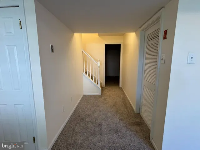 a view of hallway with wooden floor