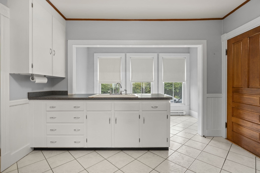 46 South Hampton Road Amesbury, MA 01913 - Photo 13 of 42 a kitchen with granite countertop white cabinets and stainless steel appliances