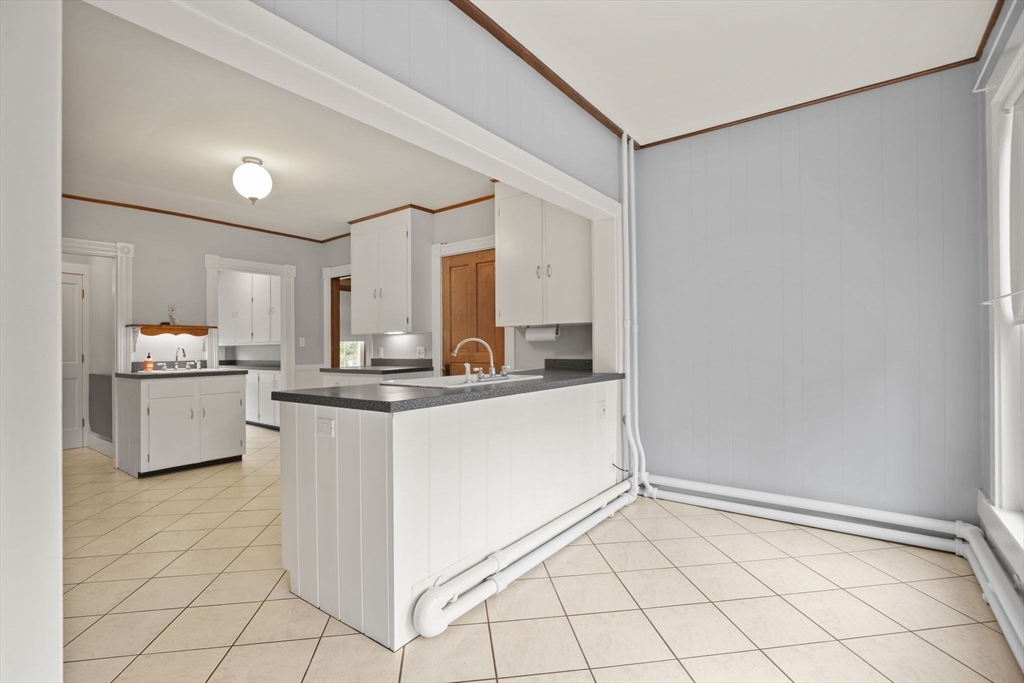 46 South Hampton Road Amesbury, MA 01913 - Photo 14 of 42 a kitchen with white cabinets and white appliances