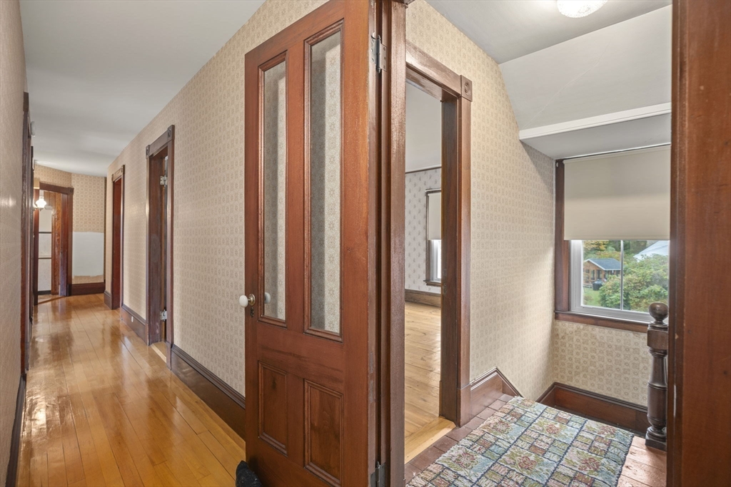 46 South Hampton Road Amesbury, MA 01913 - Photo 20 of 42 a view of a hallway with wooden floor and a bedroom