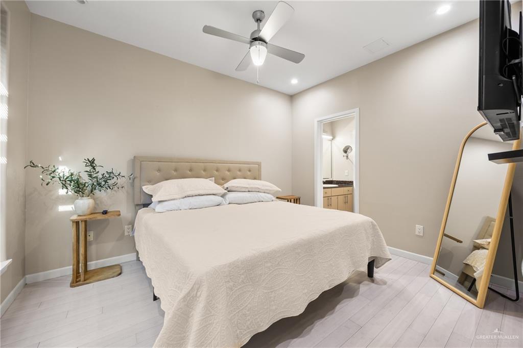 813 Travis Street, Unit 315 Mission, TX 78572 - Photo 11 of 25 a bedroom with a bed and a flat tv screen on a dresser