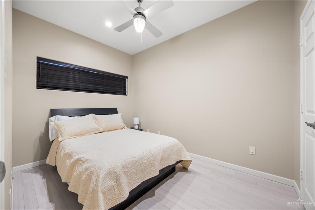 813 Travis Street, Unit 315 Mission, TX 78572 - Photo 13 of 25 a bedroom with a bed and a ceiling fan