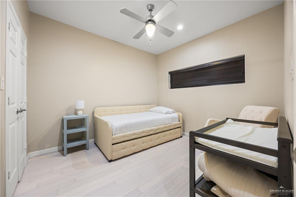 813 Travis Street, Unit 315 Mission, TX 78572 - Photo 15 of 25 a bedroom with a bed and a chandelier
