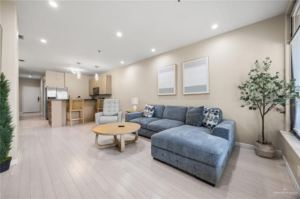 813 Travis Street, Unit 315 Mission, TX 78572 - Photo 6 of 25 a living room with furniture and a table