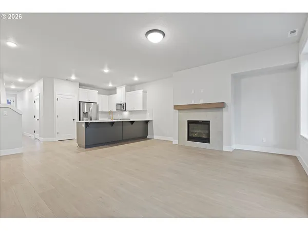 a view of an empty room with a fireplace