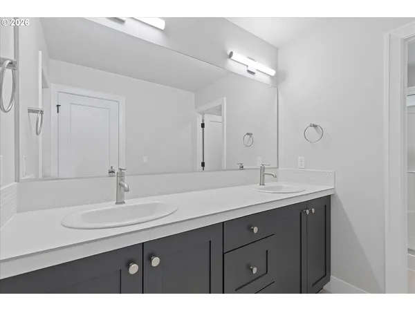 a bathroom with a sink double vanity and a mirror
