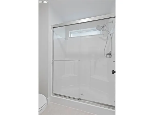 a bathroom with a glass shower door