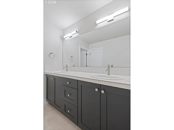 a bathroom with a double vanity sink and mirror