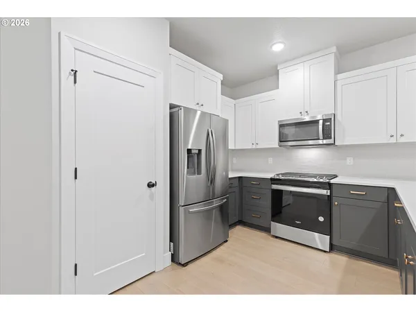 a kitchen with stainless steel appliances granite countertop a refrigerator and a stove