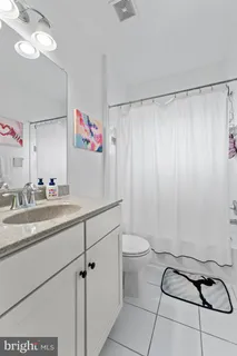 a bathroom with a sink toilet and a shower