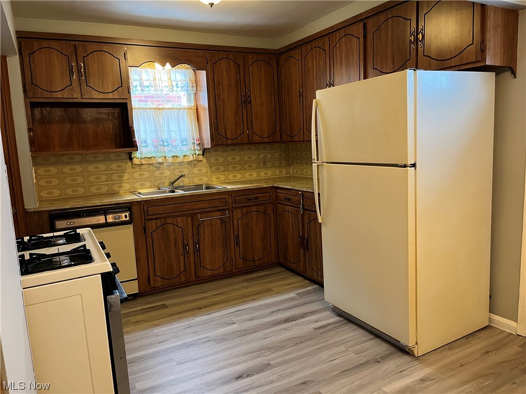 13101 Rockside Road Garfield Heights, OH 44125 - Photo 6 of 34 Kitchen with Refrigerator, Gas Stove and Refrigerator