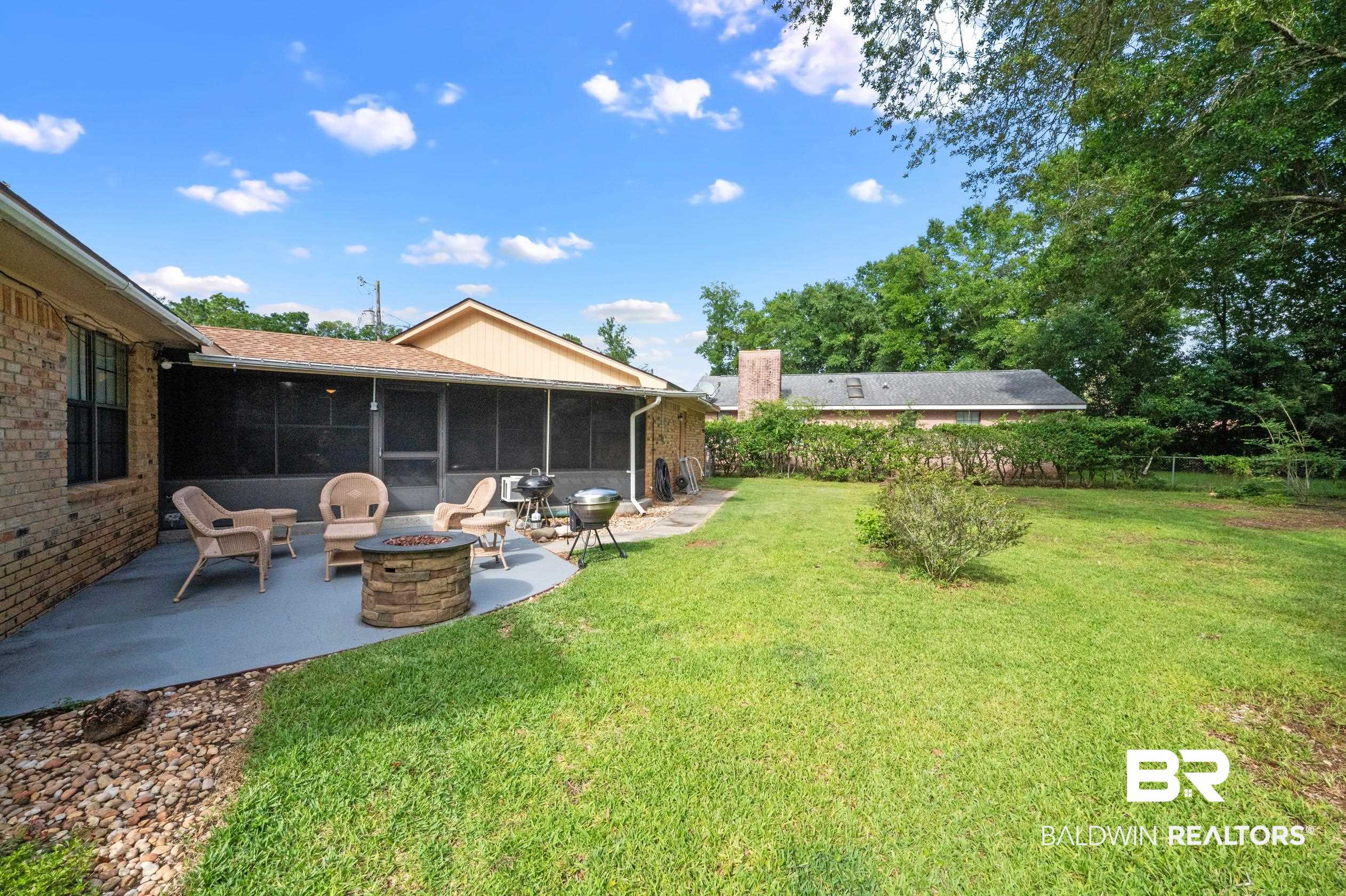 2772 Santa Rosa Circle Lillian, AL 36549 - Photo 31 of 50 View of yard with a patio, a sunroom, and an outdoor fire pit