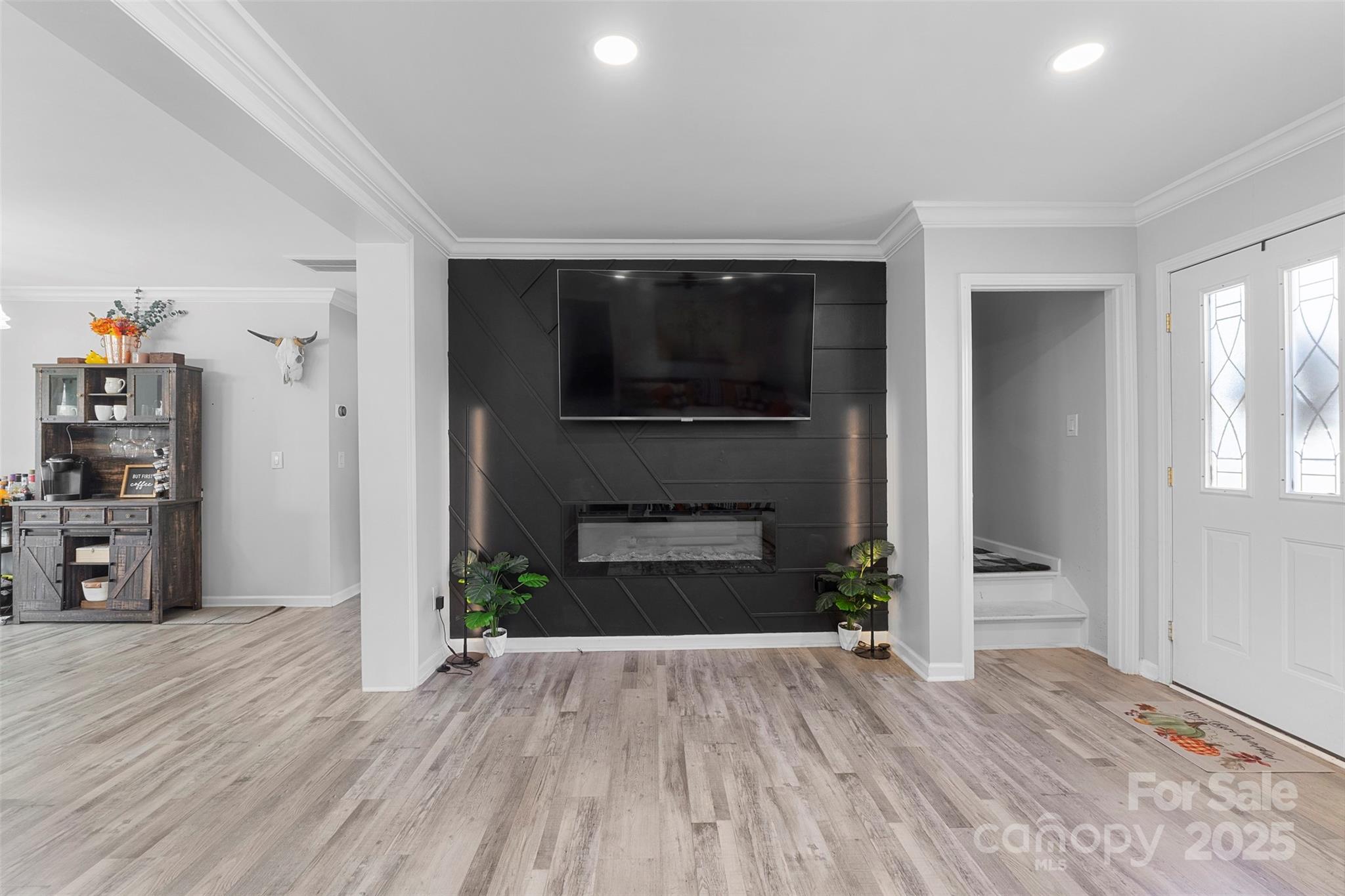 6601 Love Point Road Denver, NC 28037 - Photo 6 of 36 an empty room with wooden floor and a fireplace