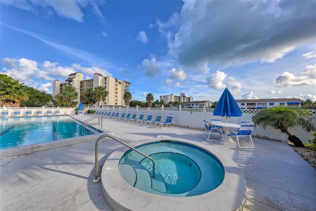 11450 Harbor Way, Unit 5002 Largo, FL 33774 - Photo 23 of 25 a swimming pool with outdoor seating and outdoor shower