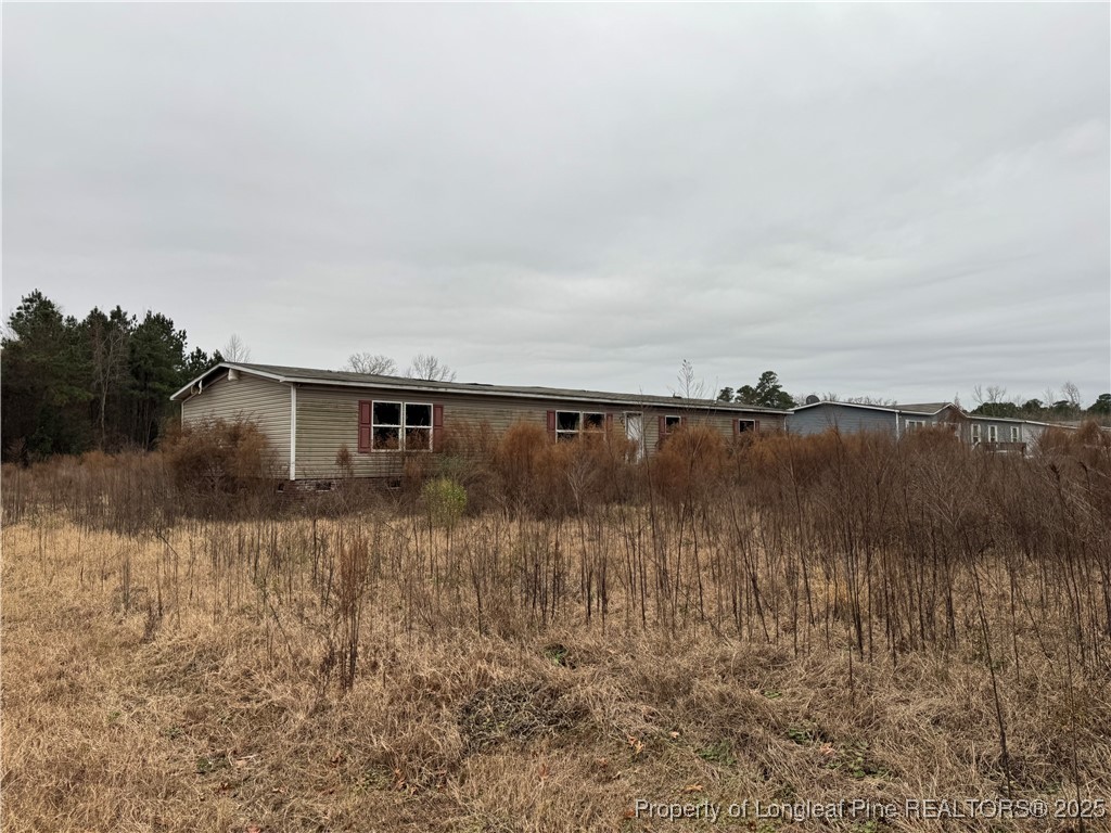 4856 Saddletree Road Lumberton, NC 28360 - Photo 2 of 9 a view of a backyard of the house