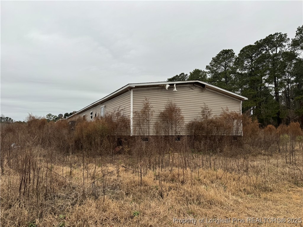 4856 Saddletree Road Lumberton, NC 28360 - Photo 3 of 9 a backyard of a house with lots of green space