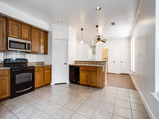 a kitchen with stainless steel appliances granite countertop a stove and a sink