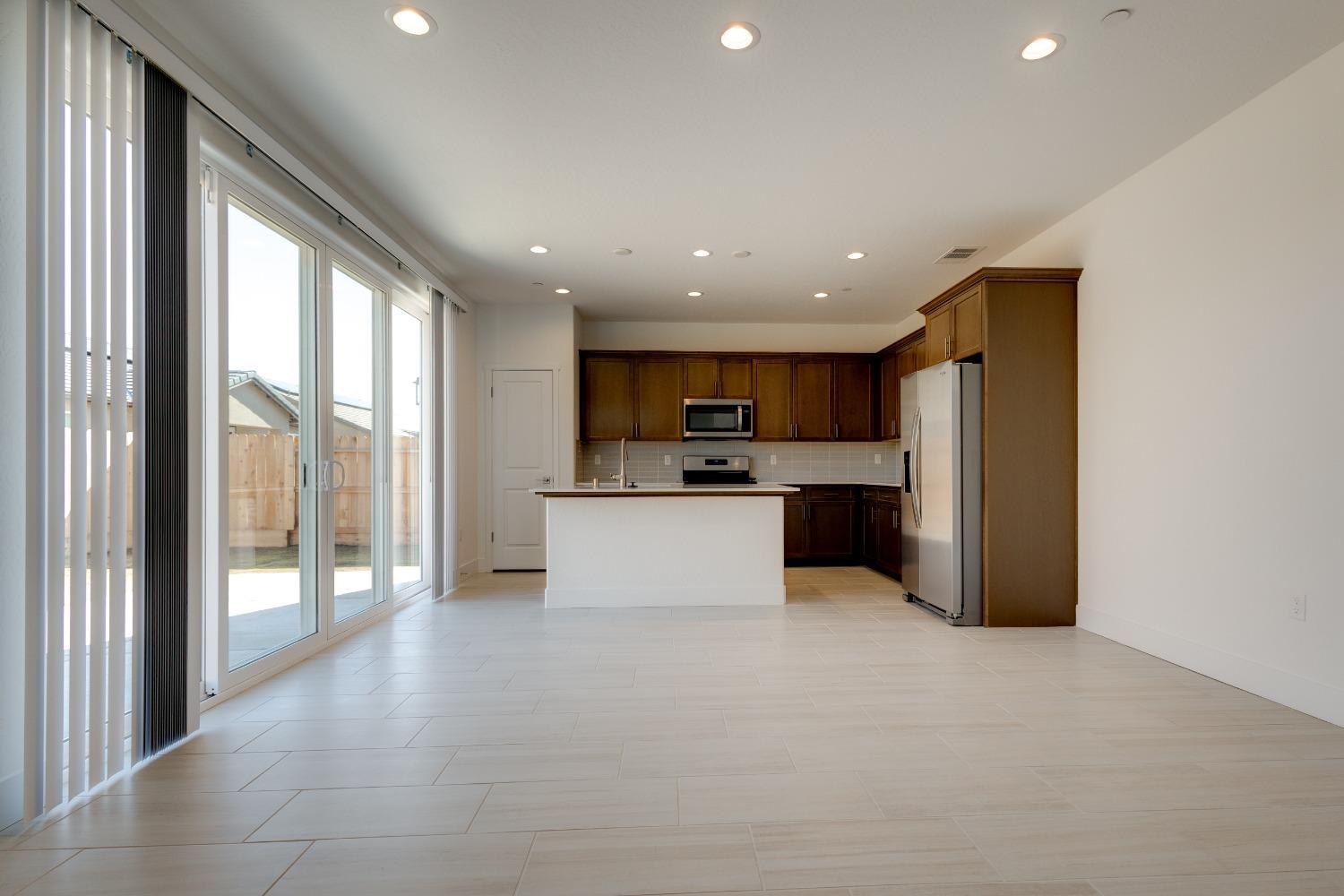 495 Thunder Road South Madera, CA 93636 - Photo 4 of 14 a view of kitchen with stainless steel appliances granite countertop a refrigerator and a sink