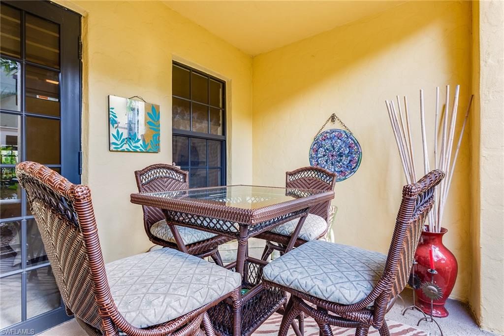 9088 Chula Vista Street, Unit 1083 Naples, FL 34113 - Photo 18 of 31 a view of a dining room with furniture