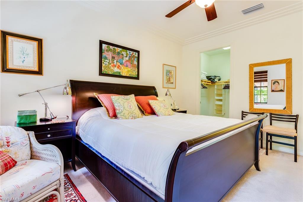 9088 Chula Vista Street, Unit 1083 Naples, FL 34113 - Photo 23 of 31 a bed room with a bed and a chair
