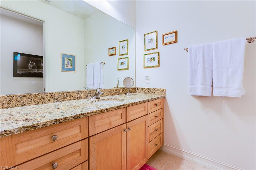 9088 Chula Vista Street, Unit 1083 Naples, FL 34113 - Photo 28 of 31 a bathroom with a sink and a mirror