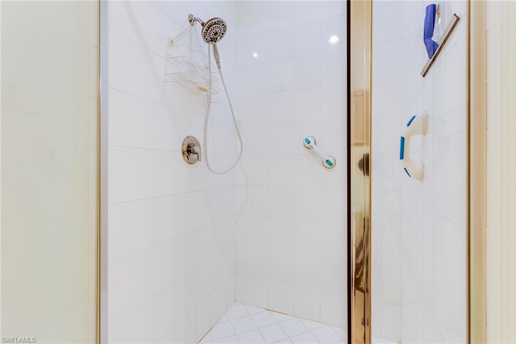 9088 Chula Vista Street, Unit 1083 Naples, FL 34113 - Photo 29 of 31 a bathroom with a shower