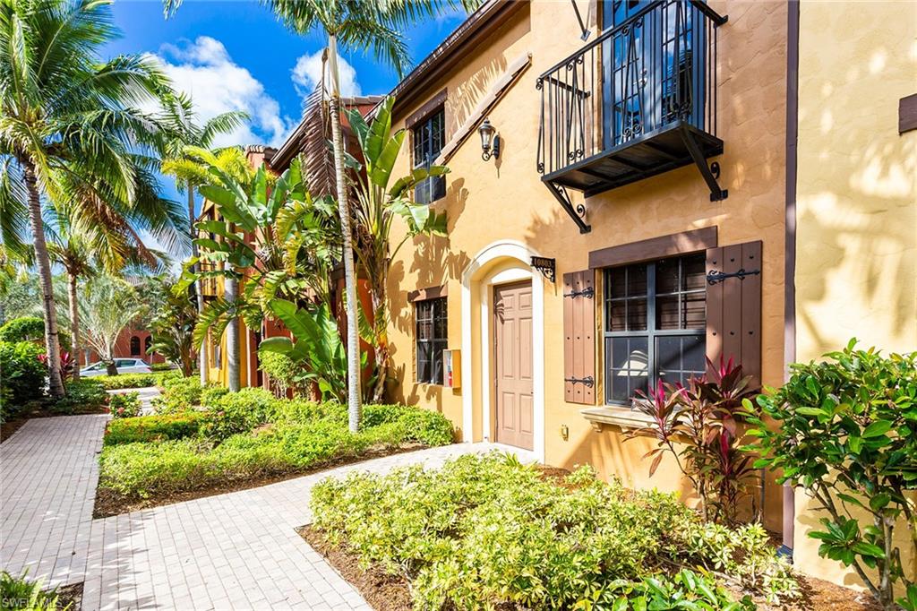 9088 Chula Vista Street, Unit 1083 Naples, FL 34113 - Photo 3 of 31 a view of a house with a flower garden