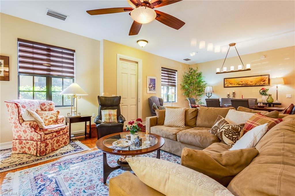 9088 Chula Vista Street, Unit 1083 Naples, FL 34113 - Photo 6 of 31 a living room with furniture kitchen view and a large window