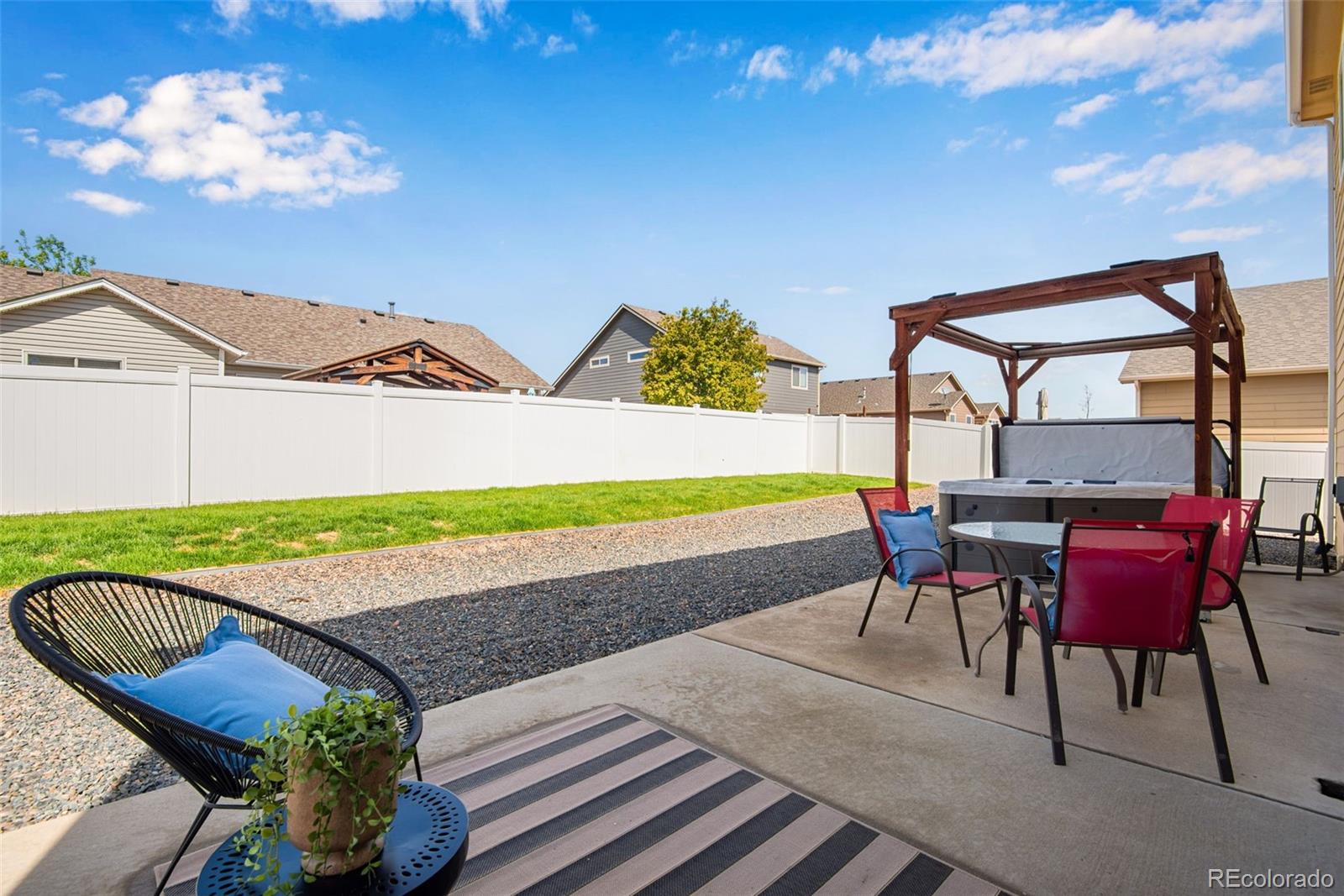 7035 McClellan Road Wellington, CO 80549 - Photo 21 of 43 a view of a chairs and table in the patio with a wooden fence