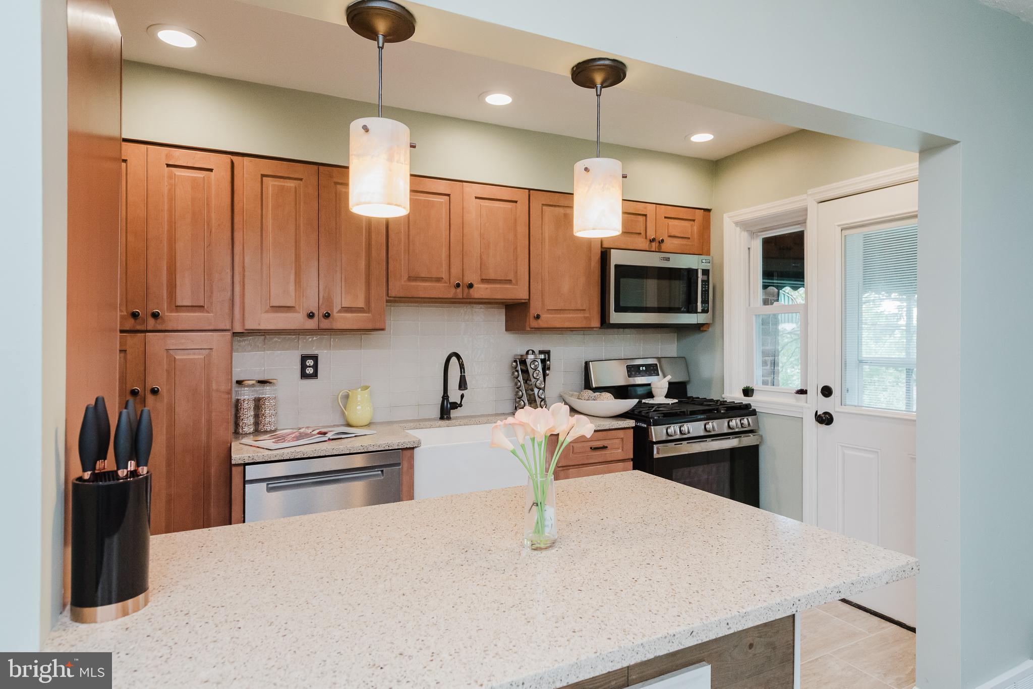 570 47th Street Baltimore, MD 21224 - Photo 11 of 41 a kitchen with stainless steel appliances granite countertop a refrigerator stove top oven a sink and dishwasher