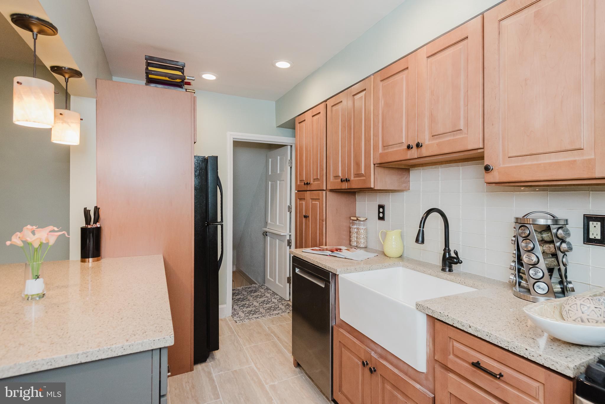 570 47th Street Baltimore, MD 21224 - Photo 13 of 41 a kitchen with stainless steel appliances a sink a stove a refrigerator cabinets and a counter space