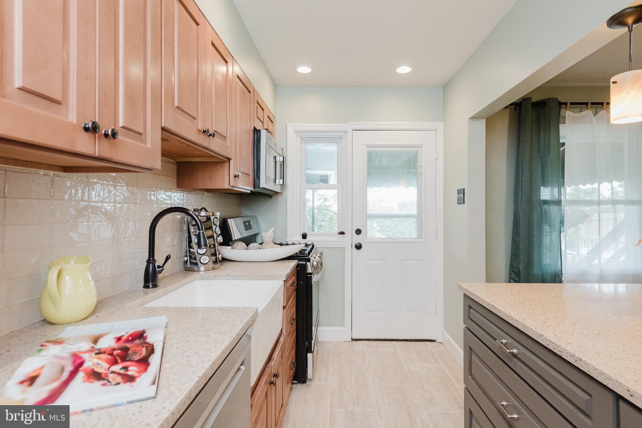 570 47th Street Baltimore, MD 21224 - Photo 15 of 41 a kitchen with a sink a stove and cabinets