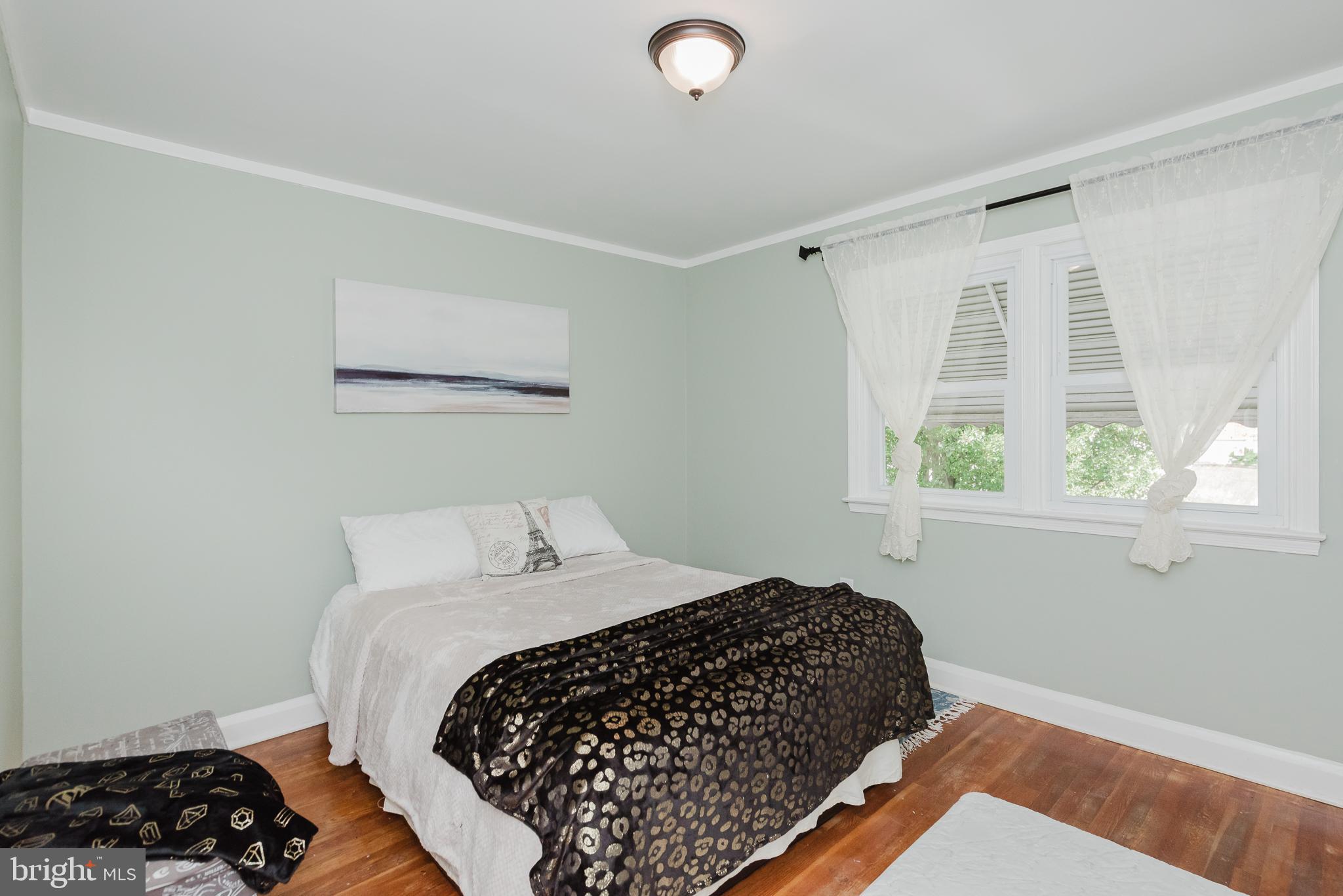 570 47th Street Baltimore, MD 21224 - Photo 16 of 41 a bedroom with a bed and a window