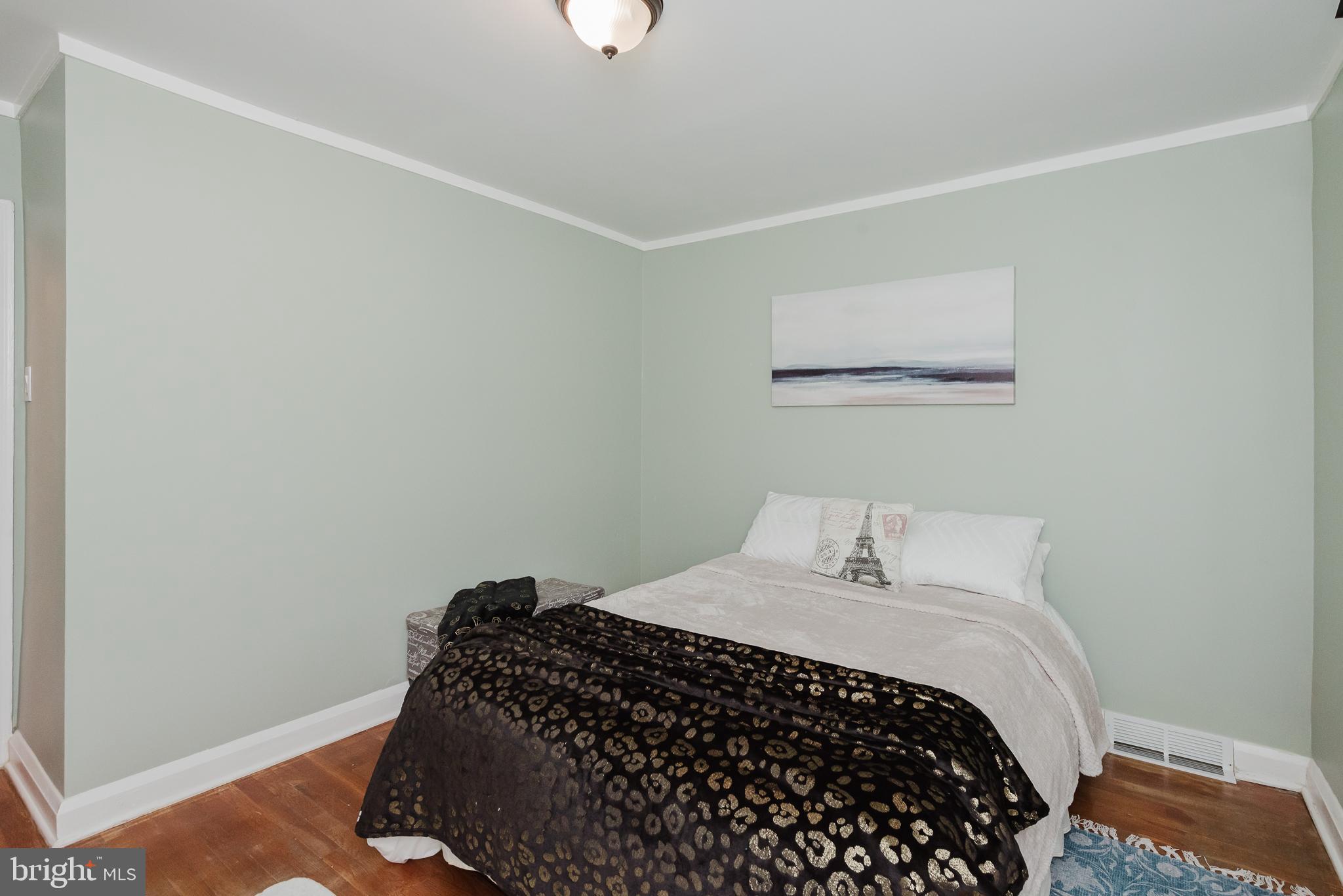 570 47th Street Baltimore, MD 21224 - Photo 17 of 41 a bedroom with a bed and a window