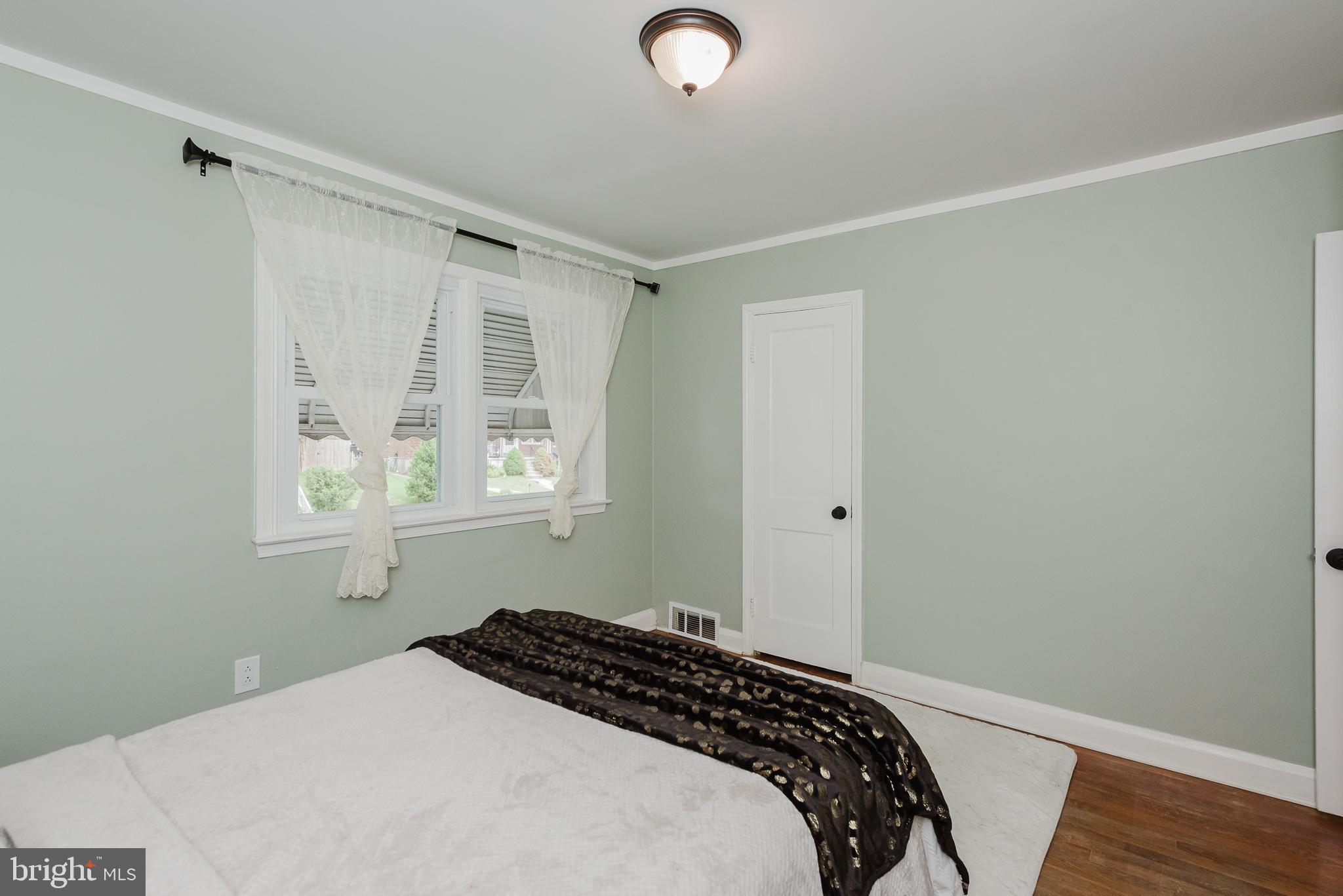 570 47th Street Baltimore, MD 21224 - Photo 19 of 41 a bedroom with a bed and a window