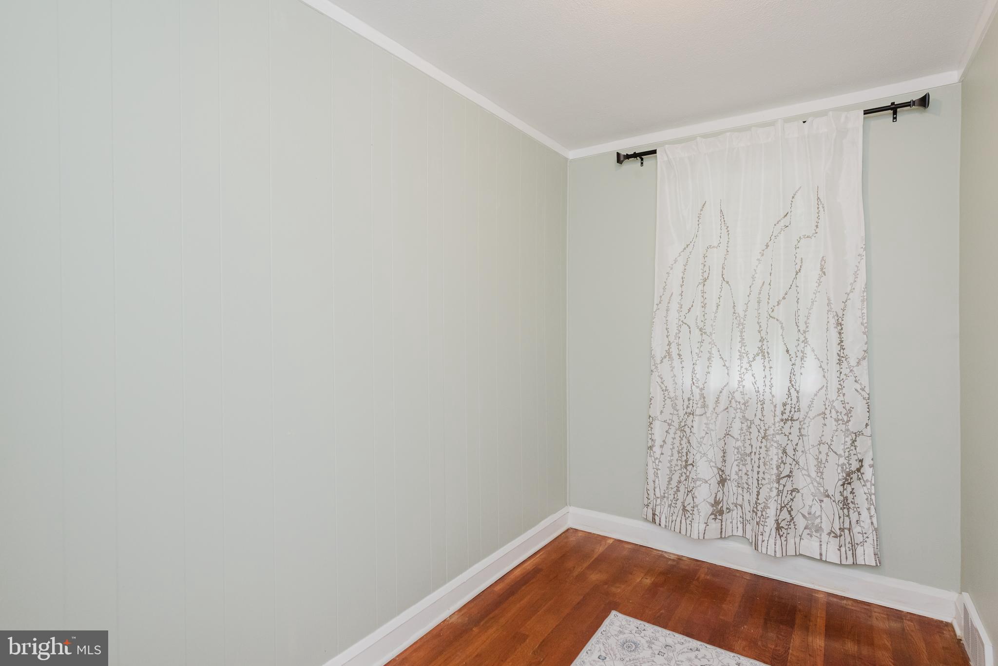 570 47th Street Baltimore, MD 21224 - Photo 24 of 41 a view of an empty room with wooden floor and a window