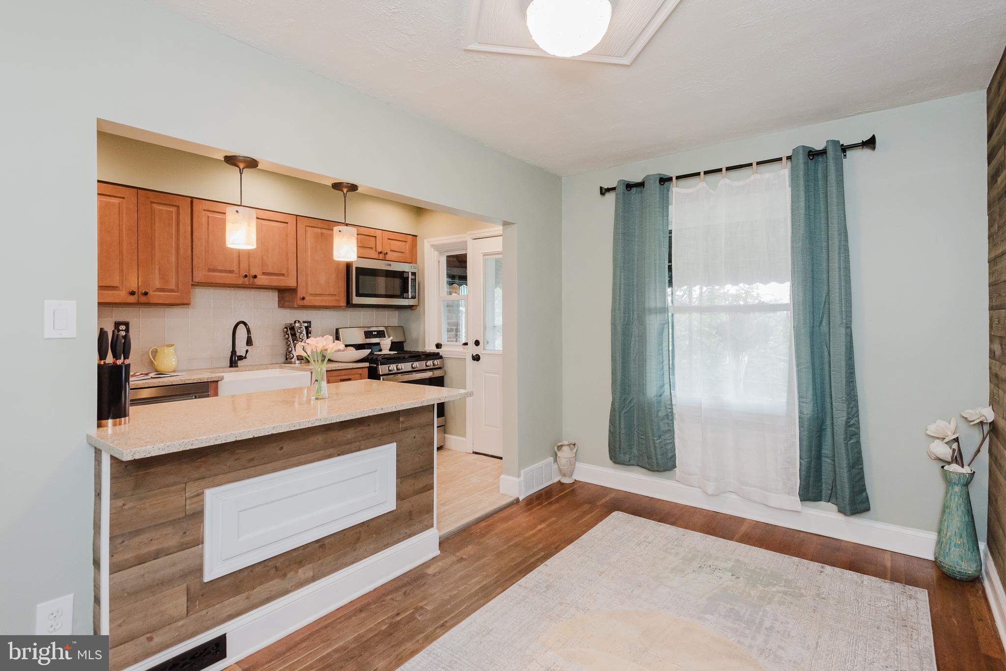 570 47th Street Baltimore, MD 21224 - Photo 9 of 41 a kitchen with stainless steel appliances granite countertop a refrigerator and a stove top oven