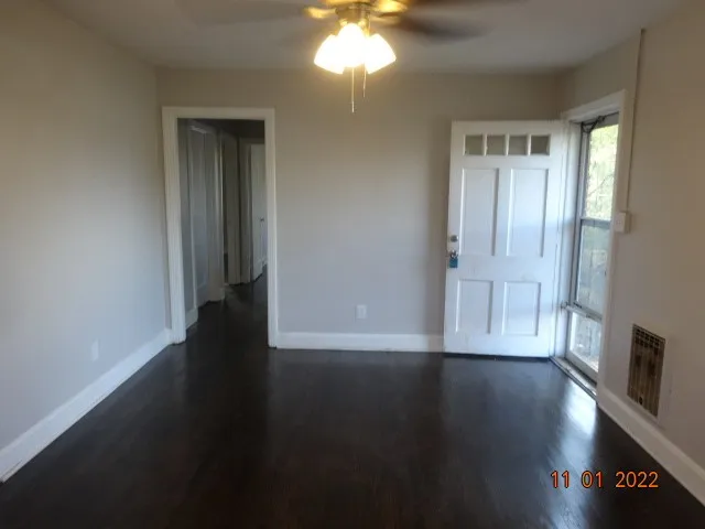 a view of a livingroom with wooden floor and a window