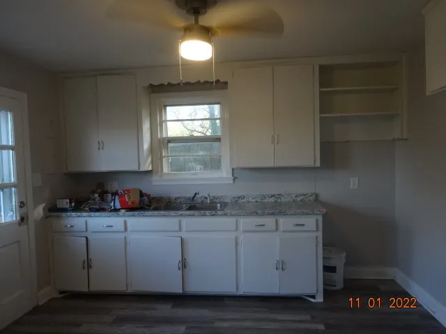a kitchen with stainless steel appliances granite countertop a sink a stove and cabinets