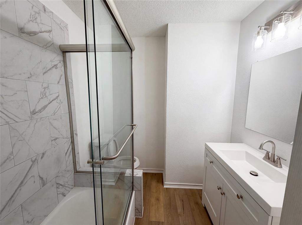 607 State Street Weatherford, TX 76086 - Photo 11 of 16 a bathroom with a sink a toilet and shower