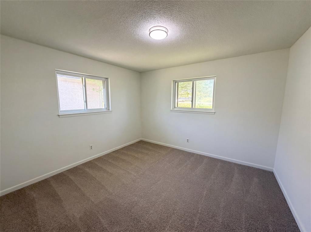 607 State Street Weatherford, TX 76086 - Photo 13 of 16 an empty room with a window