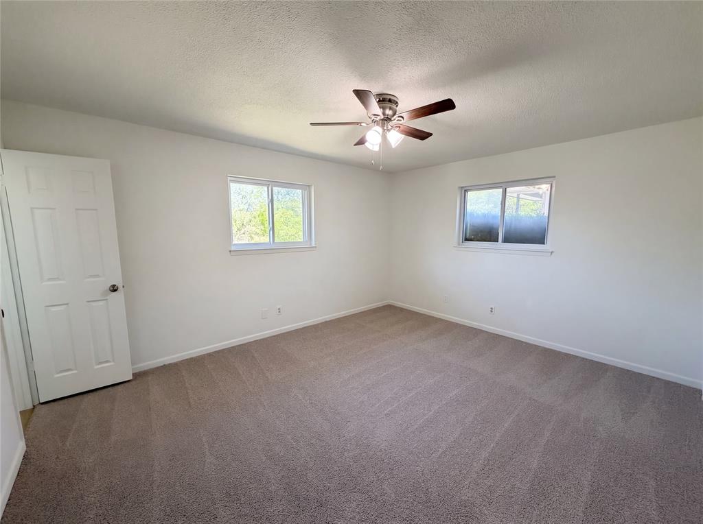 607 State Street Weatherford, TX 76086 - Photo 4 of 16 wooden floor in an empty room with a window
