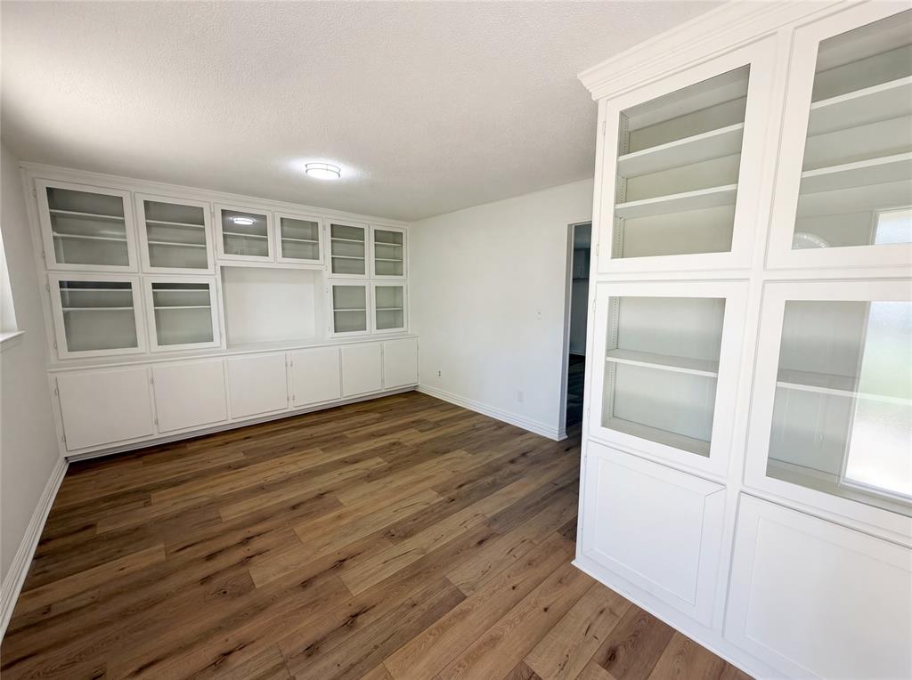 607 State Street Weatherford, TX 76086 - Photo 6 of 16 an empty room with wooden floor and windows