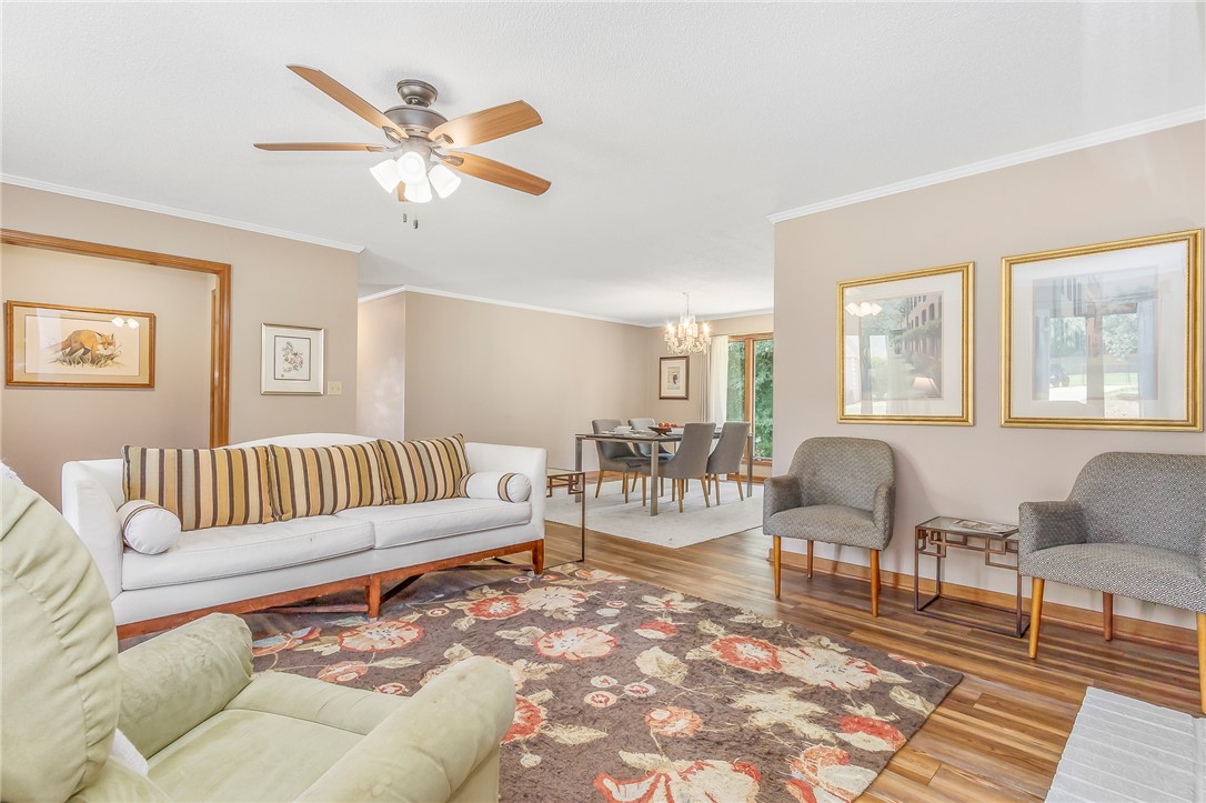 207 Laurel Ridge Road Anderson, SC 29621 - Photo 10 of 50 An inviting common area features a ceiling fan, hardwood flooring, and ample space for both relaxation and dining.